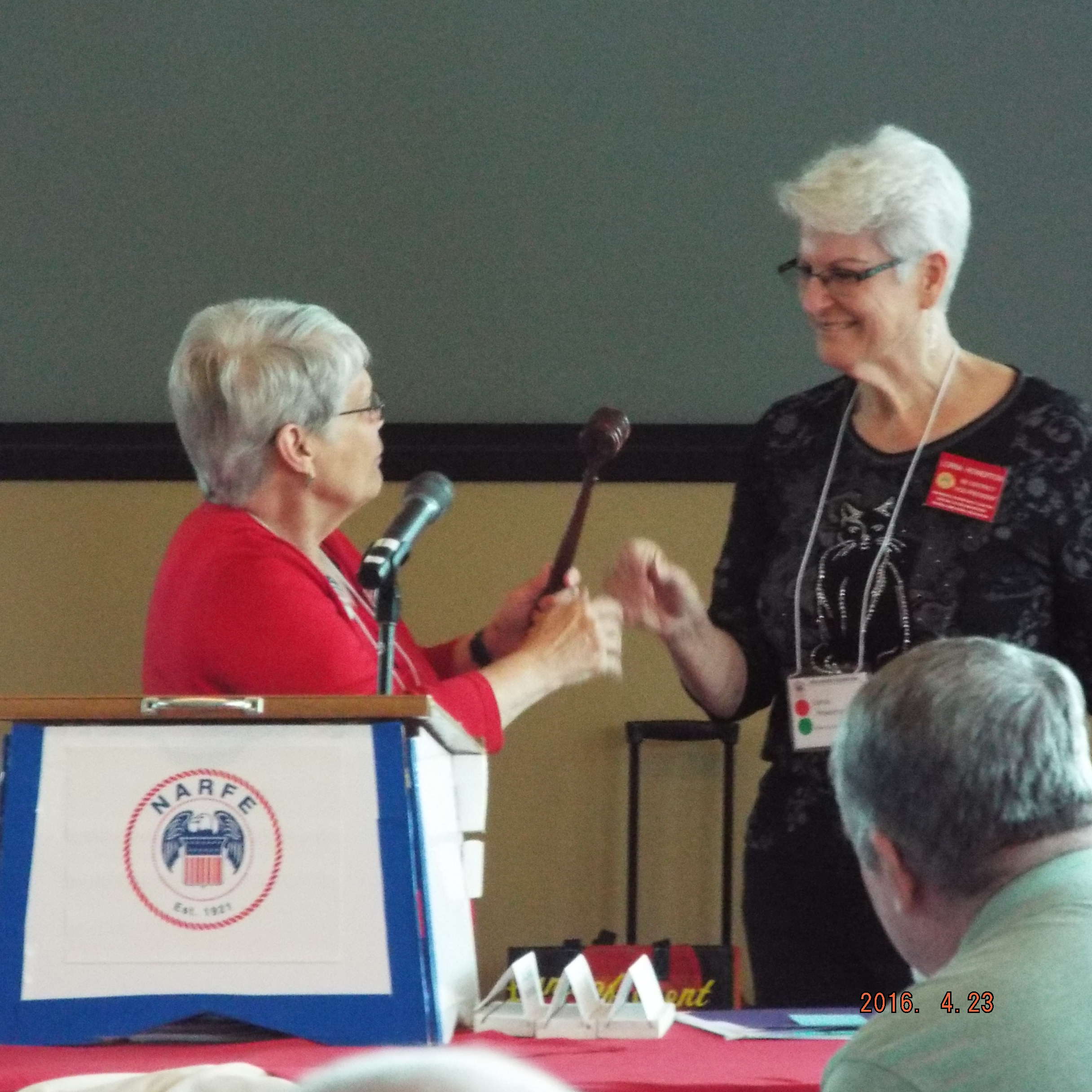 Past President Baker hands the gavel to newly elected President Howerton. Photo by Marian D Thornton